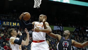 Jan 27, 2016; Atlanta, GA, USA; Atlanta Hawks center Al Horford (15) grabs a rebound against Los Angeles Clippers forward Luc Richard Mbah a Moute (12) in the first quarter of their game at Philips Arena. Also shown on the play is Atlanta Hawks guard Kyle Korver (26). Mandatory Credit: Jason Getz-USA TODAY Sports