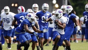 Jul 21, 2014; Pittsford, NY, USA; Buffalo Bills running back Bryce Brown (35) carries the ball as defensive back Deon Broomfield (46) pursues during training camp at St John Fisher College. Mandatory Credit: Kevin Hoffman-USA TODAY Sports