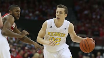 Feb 28, 2016; Madison, WI, USA; Michigan Wolverines guard Duncan Robinson (22) moves the ball as Wisconsin Badgers forward Vitto Brown (30) attempts to follow during the first half at the Kohl Center. Mandatory Credit: Mary Langenfeld-USA TODAY Sports