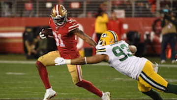 SANTA CLARA, CALIFORNIA - JANUARY 19: Raheem Mostert #31 of the San Francisco 49ers stiff arms B.J. Goodson #93 of the Green Bay Packers during the second half of the NFC Championship game at Levi's Stadium on January 19, 2020 in Santa Clara, California. (Photo by Harry How/Getty Images)