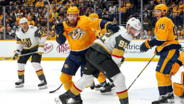 NASHVILLE, TN - NOVEMBER 27: Matt Irwin #52 of the Nashville Predators battles for the puck against Tomas Nosek #92 of the Vegas Golden Knights at Bridgestone Arena on November 27, 2019 in Nashville, Tennessee. (Photo by John Russell/NHLI via Getty Images)