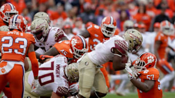 CLEMSON, SC - NOVEMBER 11: Cam Akers #3 of the Florida State Seminoles runs into Tre Lamar #57 of the Clemson Tigers during their game at Memorial Stadium on November 11, 2017 in Clemson, South Carolina. (Photo by Streeter Lecka/Getty Images)