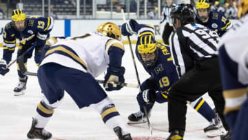 Michigan forward Adam Fantilli (19) and Notre Dame forward Jackson Pierson (11) set to face-off during the Michigan-Notre Dame NCAA hockey game on Saturday, November 12, 2022, at Compton Family Ice Arena in South Bend, Indiana.Michigan Vs Notre Dame