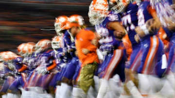 CLEMSON, SOUTH CAROLINA - NOVEMBER 17: The Clemson Tigers link arms and walk toward their end zone for their traditional "face off" prior to their football game against the Duke Blue Devils at Clemson Memorial Stadium on November 17, 2018 in Clemson, South Carolina. (Photo by Mike Comer/Getty Images)