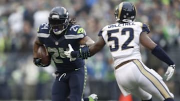 Dec 29, 2013; Seattle, WA, USA; Seattle Seahawks running back Marshawn Lynch (24) carries the ball against the St. Louis Rams during the third quarter at CenturyLink Field. Mandatory Credit: Joe Nicholson-USA TODAY Sports