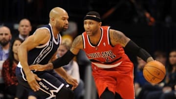 Dec 31, 2013; Oklahoma City, OK, USA; Portland Trail Blazers point guard Mo Williams (25) handles the ball while defended by Oklahoma City Thunder point guard Derek Fisher (6) during the fourth quarter at Chesapeake Energy Arena. Mandatory Credit: Mark D. Smith-USA TODAY Sports