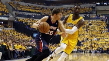 Apr 19, 2014; Indianapolis, IN, USA; Atlanta Hawks forward Kyle Korver (26) drives to the basket against Indiana Pacers center Roy Hibbert (55) in game one during the first round of the 2014 NBA Playoffs at Bankers Life Fieldhouse. Mandatory Credit: Brian Spurlock-USA TODAY Sports