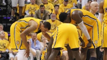 May 20, 2014; Indianapolis, IN, USA; Indiana Pacers forward Paul George (24) lays on the floor after an apparent injury as his teammates guard George Hill (3), Lance Stephenson (1) and center Roy HIbbert (33) gather around to see if he is okay against the Miami Heat center in game two of the Eastern Conference Finals of the 2014 NBA Playoffs at Bankers Life Fieldhouse. Miami defeats Indiana 87-83. Mandatory Credit: Brian Spurlock-USA TODAY Sports