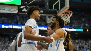Jan 7, 2023; Chapel Hill, North Carolina, USA; North Carolina Tar Heels forward Puff Johnson (14) is congratulated by guard R.J. Davis (4) after his basket against the Notre Dame Fighting Irish during the second half at Dean E. Smith Center. Mandatory Credit: James Guillory-USA TODAY Sports