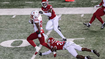 Dec 18, 2020; Piscataway, New Jersey, USA; Nebraska Cornhuskers running back Dedrick Mills (26) carries the ball as Rutgers Scarlet Knights defensive back Naijee Jones (24) tackles during the first half at SHI Stadium. Mandatory Credit: Vincent Carchietta-USA TODAY Sports