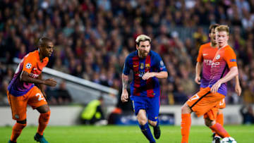 Lionel Messi (C) of FC Barcelona playes the ball between Fernandinho (L) and Kevin De Bruyne (R) of Manchester City FC . (Photo by Alex Caparros/Getty Images)
