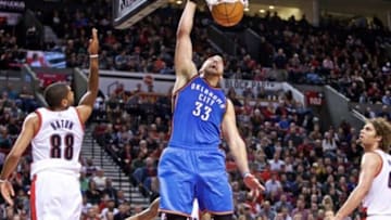 Feb 27, 2015; Portland, OR, USA; Oklahoma City Thunder forward Mitch McGary (33) dunks over Portland Trail Blazers forward Nicolas Batum (88) during the third quarter at the Moda Center. Mandatory Credit: Craig Mitchelldyer-USA TODAY Sports
