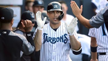 TAMPA, FL - June 12: Rehabbing New York Yankees star Giancarlo Stanton (29) of the Tarpons is congratulated by his team mates in the dugout during the Florida State League game between the Ft. Myers Miracle and the Tampa Tarpons on June 12, 2019, at Steinbrenner Field in Tampa, FL. (Photo by Cliff Welch/Icon Sportswire via Getty Images)