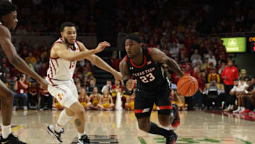 Jan 10, 2023; Ames, Iowa, USA; Texas Tech Red Raiders guard De'Vion Harmon (23) drives past Iowa State Cyclones guard Jaren Holmes (13) at James H. Hilton Coliseum. Mandatory Credit: Reese Strickland-USA TODAY Sports