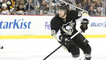 March 12, 2013; Pittsburgh, PA, USA; Pittsburgh Penguins defenseman Kris Letang (58) moves the puck up ice against the Boston Bruins third period at the CONSOL Energy Center. The Pittsburgh Penguins won 3-2. Mandatory Credit: Charles LeClaire-USA TODAY Sports