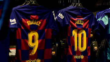 Jerseys of Barcelona's Lionel Messi, Luis Suarez (Photo by PAU BARRENA/AFP via Getty Images)