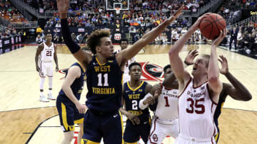 KANSAS CITY, MISSOURI - MARCH 13: Brady Manek #35 of the Oklahoma Sooners shoots as Emmitt Matthews Jr. #11 of the West Virginia Mountaineers defends during the first round game of the Big 12 Basketball Tournament at the Sprint Center on March 13, 2019 in Kansas City, Missouri. (Photo by Jamie Squire/Getty Images)