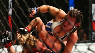 March 5, 2016; Las Vegas, NV, USA; Miesha Tate lands punches against Holly Holm during UFC 196 at MGM Grand Garden Arena. Mandatory Credit: Mark J. Rebilas-USA TODAY Sports