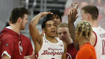 Feb 27, 2021; Madison, Wisconsin, USA; Wisconsin Badgers guard D'Mitrik Trice (0) celebrates his three-points basket i the closing minutes of the game with the Illinois Fighting Illini during the second half at the Kohl Center. Mandatory Credit: Mary Langenfeld-USA TODAY Sports
