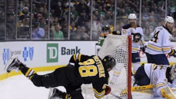 Mar 17, 2015; Boston, MA, USA; Buffalo Sabres goalie Anders Lindback (35) makes a pad save on Boston Bruins right wing David Pastrnak (88) during the third period at TD Banknorth Garden. Mandatory Credit: Bob DeChiara-USA TODAY Sports