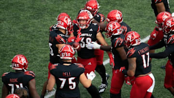 LOUISVILLE, KENTUCKY - OCTOBER 24: Jack Fagot #38 of the Louisville Cardinals celebrates with teammates after intercepting a pass against the Florida State Seminoles at Cardinal Stadium on October 24, 2020 in Louisville, Kentucky. (Photo by Andy Lyons/Getty Images)