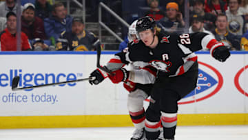 Mar 24, 2023; Buffalo, New York, USA; New Jersey Devils defenseman Jonas Siegenthaler (71) and Buffalo Sabres defenseman Rasmus Dahlin (26) go after a loose puck during the second period at KeyBank Center. Mandatory Credit: Timothy T. Ludwig-USA TODAY Sports