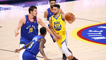 DENVER, CO - JANUARY 14: Stephen Curry #30 of the Golden State Warriors drives against Nikola Jokic #15 of the Denver Nuggets at Ball Arena on January 14, 2021 in Denver, Colorado. NOTE TO USER: User expressly acknowledges and agrees that, by downloading and/or using this photograph, user is consenting to the terms and conditions of the Getty Images License Agreement (Photo by Jamie Schwaberow/Getty Images)