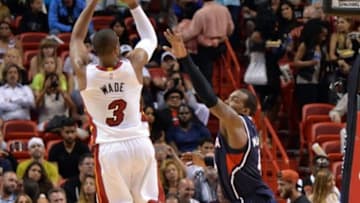 Feb 28, 2015; Miami, FL, USA; Miami Heat guard Dwyane Wade (3) shoots the ball over Atlanta Hawks forward Paul Millsap (4) during the second half at American Airlines Arena. Mandatory Credit: Steve Mitchell-USA TODAY Sports