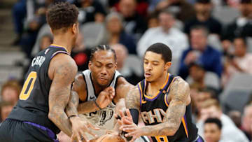 SAN ANTONIO,TX - JANUARY 05 : Kawhi Leonard #2 of the San Antonio Spurs tries to steal the ball from Tyler Ulis #8 of the Phoenix Suns as he tries to cut through the screen of of Marquese Chriss #0 of the Phoenix Suns at AT&T Center on January 05, 2018 in San Antonio, Texas. NOTE TO USER: User expressly acknowledges and agrees that , by downloading and or using this photograph, User is consenting to the terms and conditions of the Getty Images License Agreement. (Photo by Ronald Cortes/Getty Images)