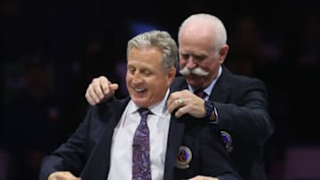 TORONTO, CANADA - NOVEMBER 12: Mike Vernon is given his Hockey Hall of Fame blazer from Lanny McDonald at Air Canada Centre on November 12, 2023 in Toronto, Ontario, Canada. (Photo by Bruce Bennett/Getty Images)