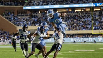 Nov 11, 2023; Chapel Hill, North Carolina, USA; North Carolina Tar Heels quarterback Drake Maye (10) goes over Duke Blue Devils safety Jaylen Stinson (2) in the third quarter at Kenan Memorial Stadium. Mandatory Credit: Bob Donnan-USA TODAY Sports