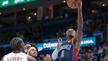 Jan 27, 2023; Oklahoma City, Oklahoma, USA; Oklahoma City Thunder guard Shai Gilgeous-Alexander (2) goes up for a basket as Cleveland Cavaliers guard Caris LeVert (3) looks on during the second half at Paycom Center. Mandatory Credit: Alonzo Adams-USA TODAY Sports