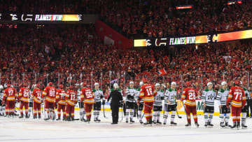 CALGARY, AB - MAY 15: The Calgary Flames shake hands with the Dallas Stars after the Flames defeated the Stars 3-2 in overtime during Game Seven of the First Round of the 2022 Stanley Cup Playoffs at Scotiabank Saddledome on May 15, 2022 in Calgary, Alberta, Canada. The Flames defeated the Stars 3-2 in overtime. (Photo by Derek Leung/Getty Images)