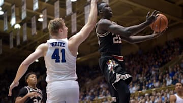 DURHAM, NC - FEBRUARY 21: Deng Adel #22 of the Louisville Cardinals drives past Jack White #41 of the Duke Blue Devils during their game at Cameron Indoor Stadium on February 21, 2018 in Durham, North Carolina. Duke won 82-56. (Photo by Grant Halverson/Getty Images)
