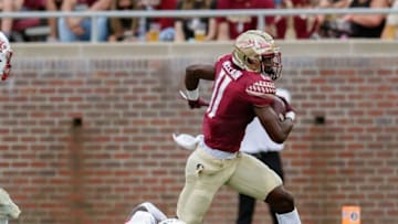 Florida State Seminoles wide receiver Malik McClain (11) continues to run to avoid a tackle. The Louisville Cardinals lead the Florida State Seminoles 31-13 at the half Saturday, Sept. 25, 2021.Fsu V Louisville Football250