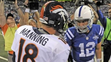 Oct 20, 2013; Indianapolis, IN, USA; Denver Broncos quarterback Peyton Manning (18) shakes hands with Indianapolis Colts quarterback Andrew Luck (12) before the game at Lucas Oil Stadium. Mandatory Credit: Thomas J. Russo-USA TODAY Sports
