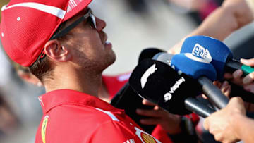 MONZA, ITALY - AUGUST 30: Sebastian Vettel of Germany and Ferrari talks to the media in the Paddock during previews ahead of the Formula One Grand Prix of Italy at Autodromo di Monza on August 30, 2018 in Monza, Italy. (Photo by Charles Coates/Getty Images)