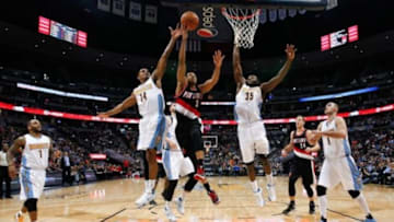 Jan 3, 2016; Denver, CO, USA; Denver Nuggets guard Gary Harris (14) and forward Kenneth Faried (35) defend on a shot from Portland Trail Blazers guard C.J. McCollum (3) in the third quarter at the Pepsi Center. The Trail Blazers defeated the Nuggets 112-106. Mandatory Credit: Isaiah J. Downing-USA TODAY Sports