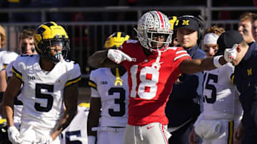 Nov 26, 2022; Columbus, Ohio, USA; Ohio State Buckeyes wide receiver Marvin Harrison Jr. (18) celebrates a first down in front of Michigan Wolverines defensive back DJ Turner (5) during the first half of the NCAA football game at Ohio Stadium. Mandatory Credit: Adam Cairns-The Columbus Dispatch