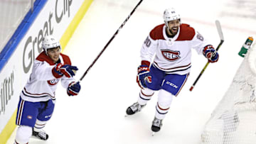 TORONTO, ONTARIO - AUGUST 14: Jake Evans #71 and Alex Belzile #60 of the Montreal Canadiens celebrate after Joel Armia (not pictured) #40 scored a goal on Carter Hart #79 of the Philadelphia Flyers during the second period in Game Two of the Eastern Conference First Round during the 2020 NHL Stanley Cup Playoffs at Scotiabank Arena on August 14, 2020 in Toronto, Ontario, Canada. (Photo by Elsa/Getty Images)