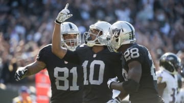 September 20, 2015; Oakland, CA, USA; Oakland Raiders wide receiver Seth Roberts (10) is congratulated by tight end Mychal Rivera (81) and running back Latavius Murray (28) after a 12-yard touchdown catch during the fourth quarter against the Baltimore Ravens at O.co Coliseum. The Raiders defeated the Ravens 37-33. Mandatory Credit: Kyle Terada-USA TODAY Sports