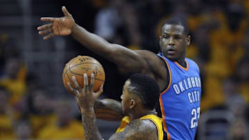 Jan 25, 2015; Cleveland, OH, USA; Oklahoma City Thunder guard Dion Waiters (23) defends a shot by Cleveland Cavaliers guard J.R. Smith (5) in the first quarter at Quicken Loans Arena. Mandatory Credit: David Richard-USA TODAY Sports