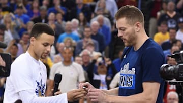 March 25, 2016; Oakland, CA, USA; Golden State Warriors guard Stephen Curry (30) gives Dallas Mavericks forward David Lee (42) his NBA championship ring before the game at Oracle Arena. Mandatory Credit: Kyle Terada-USA TODAY Sports