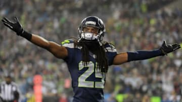 January 10, 2015; Seattle, WA, USA; Seattle Seahawks cornerback Richard Sherman (25) reacts after free safety Earl Thomas (29) intercepts a pass against the Carolina Panthers during the first half in the 2014 NFC Divisional playoff football game at CenturyLink Field. Mandatory Credit: Kirby Lee-USA TODAY Sports
