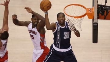 Mar 21, 2014; Toronto, Ontario, CAN; Oklahoma City Thunder forward Kevin Durant (35) goes to the basket and scores past Toronto Raptors forward Amir Johnson (15) at Air Canada Centre. Mandatory Credit: Tom Szczerbowski-USA TODAY Sports