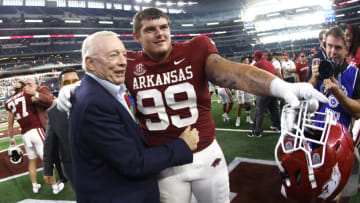 ARLINGTON, TX - SEPTEMBER 25: Dallas Cowboys owner and general manager Jerry Jones celebrates with John Ridgeway #99 of the Arkansas Razorbacks following the teams 20-10 win over the Texas A&M Aggies in the Southwest Classic at AT&T Stadium on September 25, 2021 in Arlington, Texas. (Photo by Ron Jenkins/Getty Images)