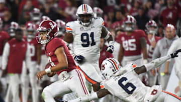 Auburn football Nov 26, 2022; Tuscaloosa, Alabama, USA; Alabama Crimson Tide quarterback Bryce Young (9) scrambles for a first down against Auburn Tigers cornerback Keionte Scott (6) at Bryant-Denny Stadium. Alabama won 49-27. Mandatory Credit: Gary Cosby Jr.-USA TODAY Sports