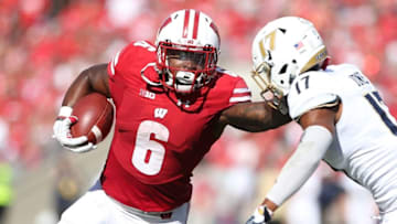 Sep 10, 2016; Madison, WI, USA; Wisconsin Badgers running back Corey Clement (6) stiff arms Akron Zips defensive back Bryce Jones (17) during the game against the Akron Zips at Camp Randall Stadium. Wisconsin defeated Akron 54-10. Mandatory Credit: Mary Langenfeld-USA TODAY Sports