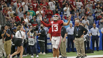 SAN ANTONIO, TX - DECEMBER 29: Caleb Williams #13 of the Oklahoma Sooners gets the crowd up as he enters the stadium before the Valero Alamo Bowl against Oregon at the Alamodome on December 29, 2021 in San Antonio, Texas. (Photo by Ronald Cortes/Getty Images)