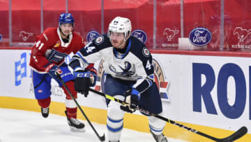 MONTREAL, QC - FEBRUARY 22: Dylan Samberg #44 of the Manitoba Moose skates the puck past Ryan Poehling #41 of the Laval Rocket during the second period at the Bell Centre on February 22, 2021 in Montreal, Canada. The Manitoba Moose defeated the Laval Rocket 3-2 in overtime. (Photo by Minas Panagiotakis/Getty Images)